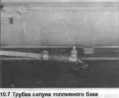 7. Disconnect the breather tube from the top of the tank (photo).
