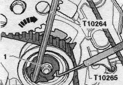 Loosen nut «1» of the tension roller and remove locking pin «T10265». Ignore the «arrow».