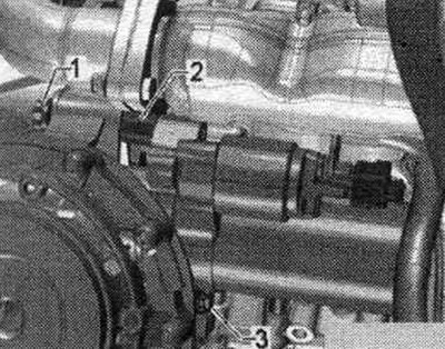 Unscrew the starter bolt «1». Remove the spacer sleeve «2» between the starter and the gearbox.