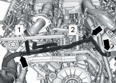 38.4. Clamps (arrows) for fastening hoses to the PCV pipe.